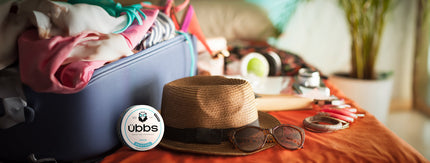 Summer holiday items – sun hat, suitcase, with übbs nicotine pouch can