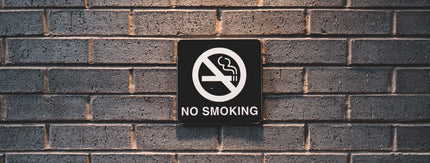 black no smoking sign on brick wall