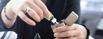woman holding handful of cigarettes while other hand signals no