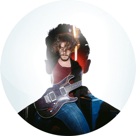 Man playing guitar inside silhouette of head